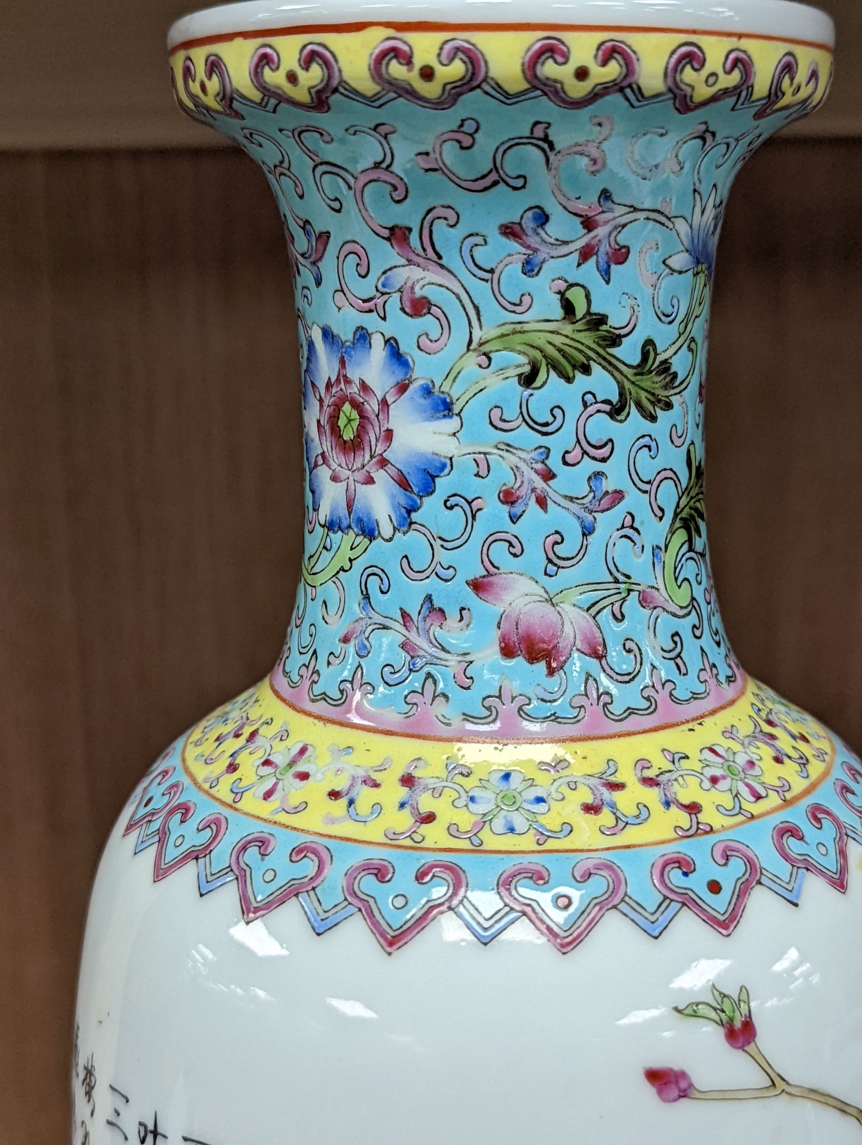 A pair of Chinese famille rose vases decorated with peacocks, 31cm